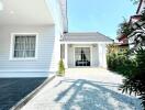 Front of modern house with a gravel pathway and a covered entrance