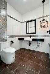 Modern bathroom with wall-mounted sink and stylish lighting