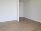 Spacious empty room with wooden flooring