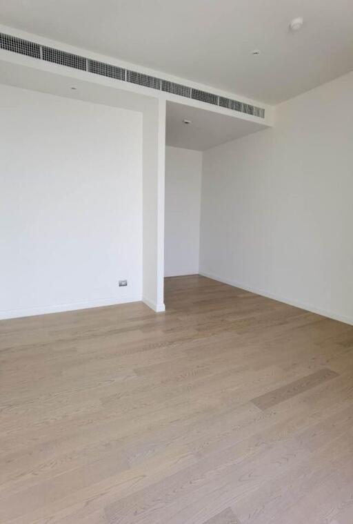 Spacious empty room with wooden flooring