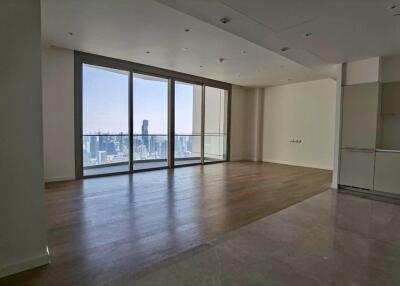 Spacious living room with large windows and city view