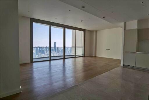 Spacious living room with large windows and city view