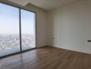 Bedroom with large window and city view