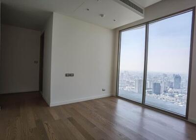 Spacious bedroom with large window offering city view