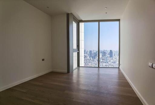 empty room with large floor-to-ceiling window and city view