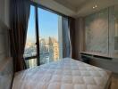 High-rise bedroom with a city view