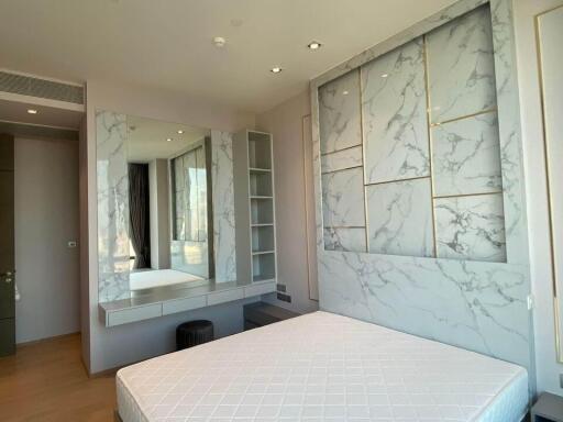 Modern bedroom with marble accent wall and large mirror