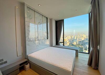 Modern bedroom with large windows and city view