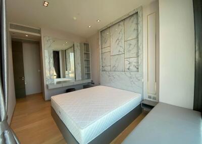 Modern bedroom with a large bed and wall-mounted mirror