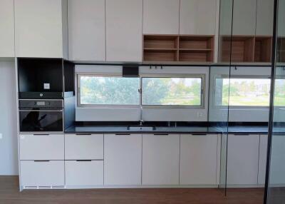 Modern kitchen with built-in appliances and large windows