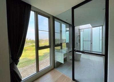 Modern bathroom with large windows and glass shower enclosure