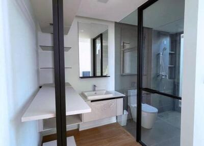 Modern bathroom with glass shower and ample shelving