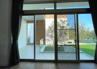 Living area with large glass doors leading to a balcony and outdoor view