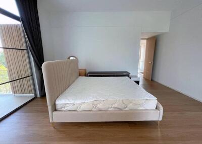 Spacious bedroom with large bed and balcony access