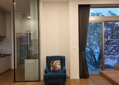 Modern living room with blue armchair and large window