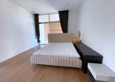 Bedroom with large window, modern bed, and curtains