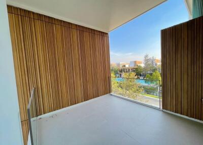 Spacious balcony with wooden paneling and scenic view