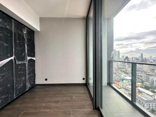 Interior view of a room with large windows overlooking a cityscape