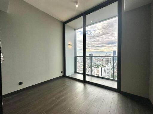 Modern bedroom with large windows offering city view