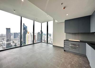 Spacious living room with city view and built-in kitchen appliances