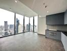 Spacious living room with city view and built-in kitchen appliances