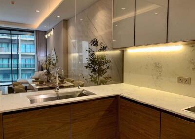 Modern kitchen with marble countertops and adjacent dining area