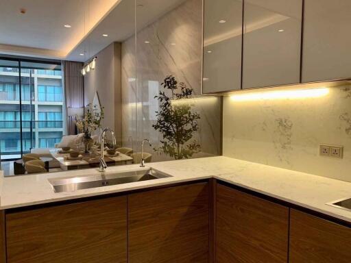 Modern kitchen with marble countertops and adjacent dining area