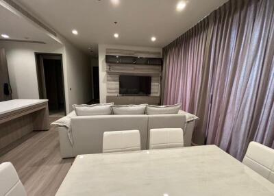 Modern living room with sofa, TV, and dining area