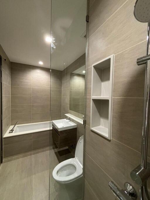 Modern bathroom with bathtub, shower, and toilet