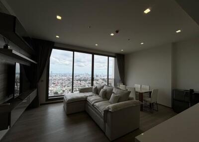 Modern living room with large windows offering city view