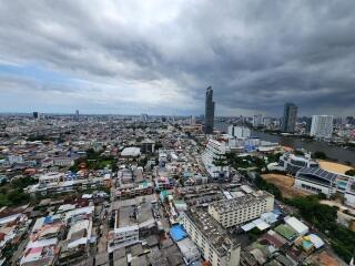 Aerial view of a city with high-rise buildings and cloudy sky