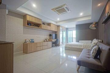 Spacious bedroom with work area and modern furniture