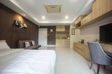 Modern bedroom with wooden furniture and white tiles