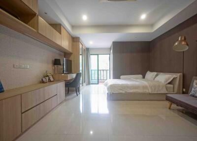 Spacious bedroom with modern furniture and natural lighting