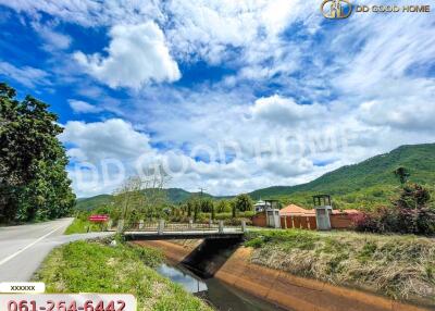 Beautiful landscape view with mountains, a bridge, and a canal