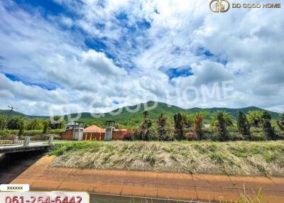 Scenic view of the house with a mountain and lush greenery