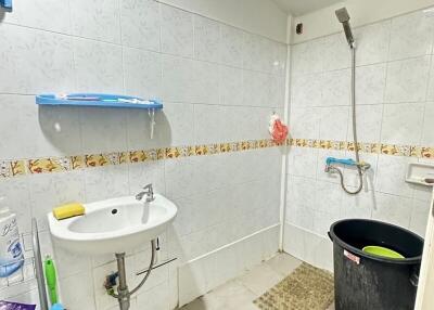 Bathroom with sink, shower, and various items