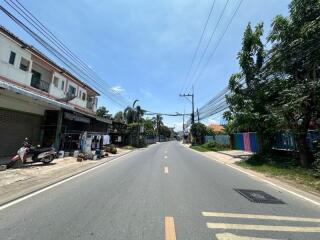 Street view showing residential buildings and greenery