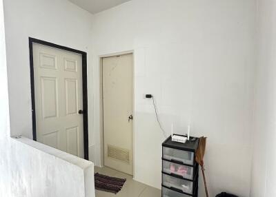 Small hallway with two doors and a storage unit