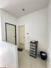 Small hallway with two doors and a storage unit