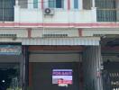 Two-story townhouse with a 'For Sale' sign