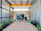 Covered outdoor area with plants and tiled floor