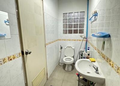 Clean and well-lit bathroom with essential fixtures