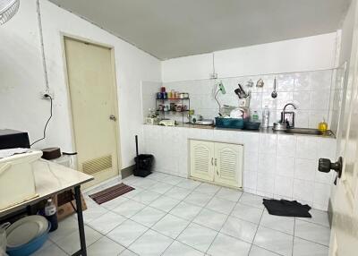 Simple kitchen with white cabinets and tiled floor