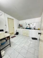 Simple kitchen with white cabinets and tiled floor