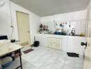 Simple kitchen with white cabinets and tiled floor