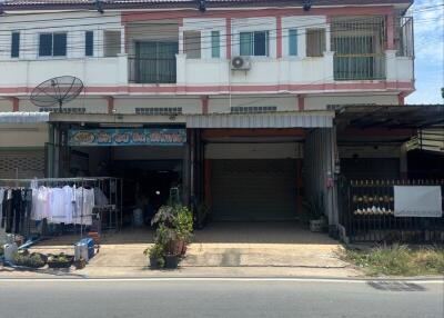 Front view of a commercial building with shops and residential space