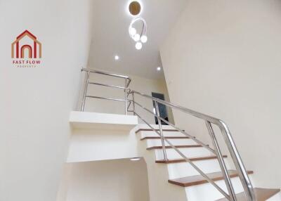 Modern staircase with sleek handrails and wooden steps