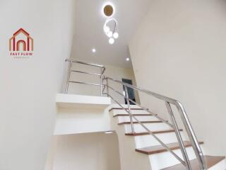 Modern staircase with sleek handrails and wooden steps