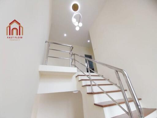 Modern staircase with sleek handrails and wooden steps